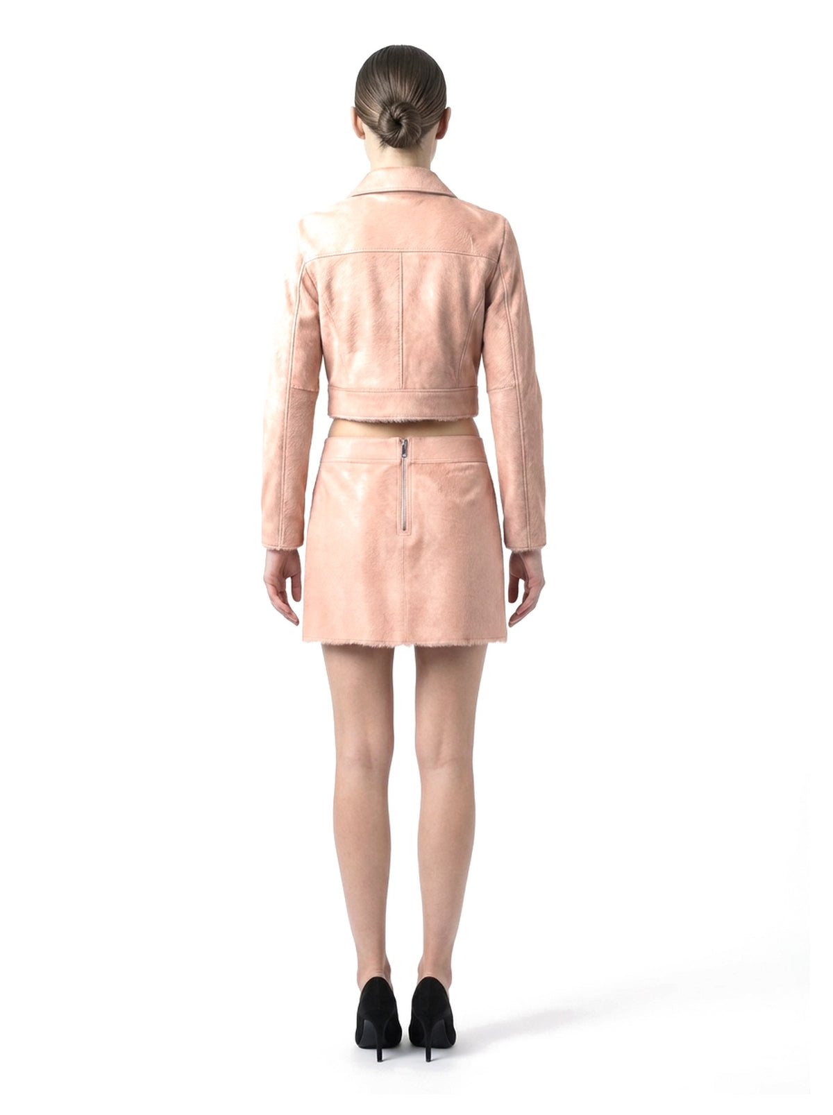 Ensemble veste courte et jupe courte en poil de veau à ras rose, porté par un mannequin, vue de dos.